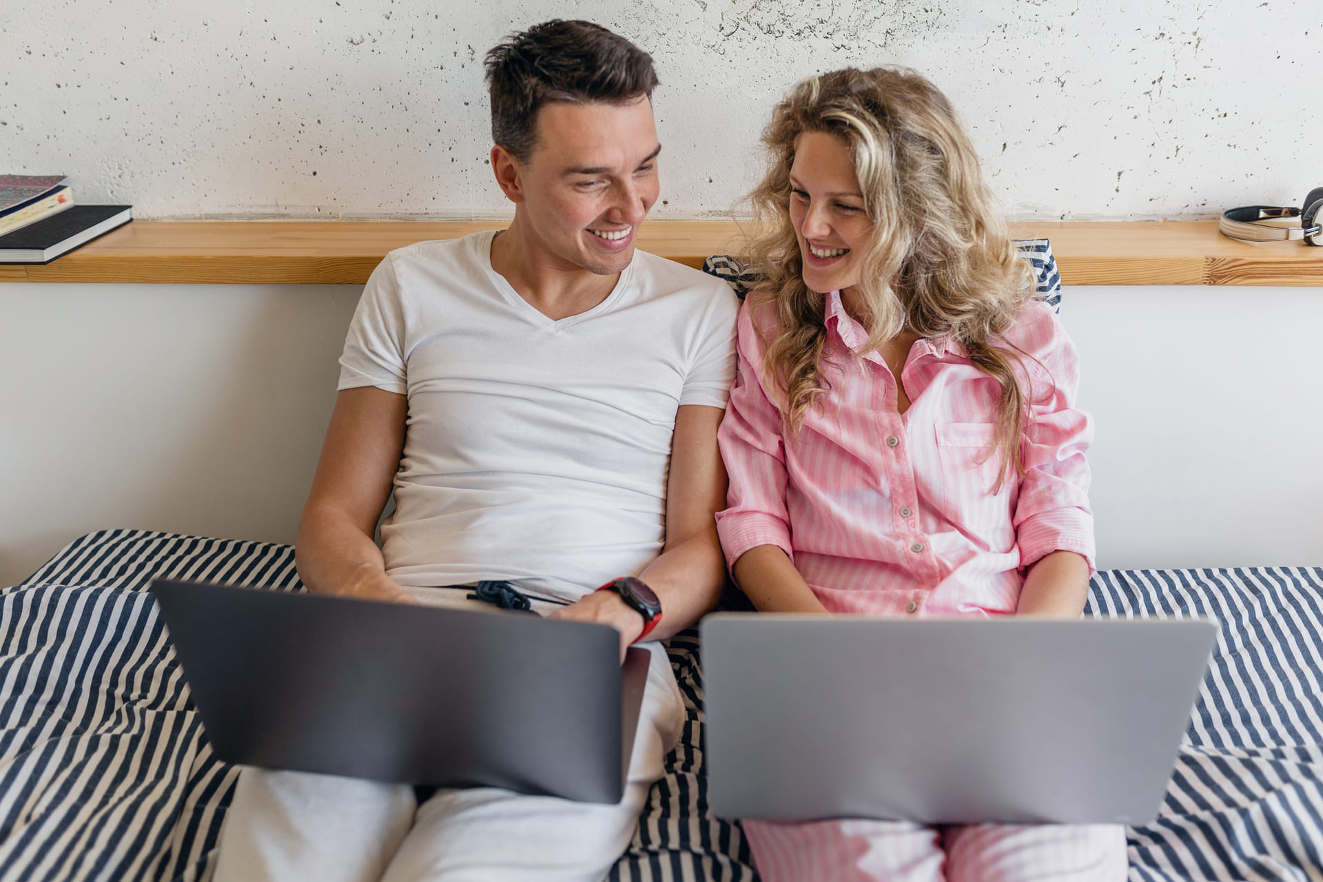 Couple using laptops for financial planning